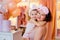 A young mother and daughter in pink pajamas are hugging in the dressing room