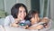 Young mother and daughter playing video game