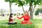 A young mother and daughter in sportswear do yoga together in a Park. The concept of a family holiday. Sports, fitness, meditation