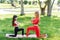 A young mother and daughter in sportswear do yoga together in a Park. The concept of a family holiday. Sports, fitness, meditation