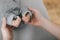 Young mother or doctor hands holding little feet barefoot of newborn on gray background. Happy moment of parenthood. Close-up