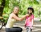 Young mother dresses her daughter\'s bicycle helmet