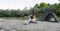 Young mother explores beach with her daughter