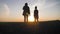 Young mother farmer teaches her daughter to work in a wheat field. Silhouette of a farmers family in a wheat field at