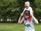 Young mother happily spending time with a young child in a summer park.