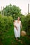 Young mother with her baby girl walking through a vineyard in summer playing and tasting fruits before the harvest at sunset.