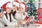 Young mother and her children making Christmas decorations sitting at the table