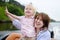 Young mother and her little son enjoy boating