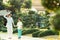 Young mother and her little son walking in Green bonsai trees gardens in Wat Arun