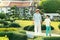 Young mother and her little son walking in Green bonsai trees gardens in Wat Arun