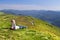 Young mother and her newborn baby relaxing high in mountains