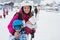 Young mother, her preschool boy and her toddler baby in sling ca