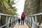 Young mother and her toddler son walking together down the medieval streets of Bergamo city northeast of Milan. Scenic views of