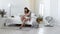 Young mother holding her newborn child. Mom nursing baby. Woman and new born boy relax in a white bedroom. Mother breast