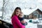 Young mother, holding her toddler boy on a terrace, winter lands