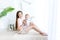 Young mother holds baby son 1 year in a photo Studio on a light background, family day, mother`s day