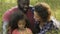 Young mother kissing and hugging adopted daughter, happy multi-racial family