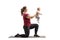 Young mother kneeling on an exercise mat and holding her baby