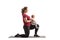 Young mother kneeling and exercisingwith her baby girl