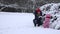 Young mother and little baby girl have fun with snow. 4K