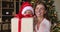 Young mother and little girl congratulate with Christmas by videocall