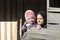 Young mother and a little girl in her hug portrait in wooden hut