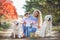 A young mother with a little girl and two dogs on a walk in the Park in autumn