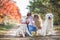 A young mother with a little girl and two dogs on a walk in the Park in autumn