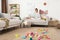 Young mother meditating on sofa in messy living room