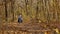 Young mother and nice daughter enjoy autumnal nature