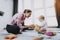 Young Mother Playing Toys with Baby on Carpet