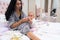 Young mother preparing a bottle feed for her baby.