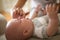 Young mother rubs teeth of her little baby boy with gel.