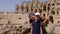 Young mother showing to daughter ancient amphitheater Gordian in El Jem Tunisia