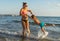 Young mother and smiling baby boy son playing on the beach in the day time. Positive human emotions, feelings, joy. Funny cute chi