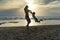 Young mother and smiling baby boy son playing on the beach on the Sunset. Positive human emotions, feelings, joy. Funny cute child