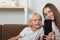 Young mother and son look into smartphone and smile. Selfie on phone