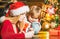 Young mother and son write a letter to Santa. Winter holidays and childhood concept. Helper of Santa with wishlist for