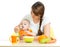 Young mother spoon feeding her baby girl at desk