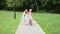 Young mother teaches her daughter to ride a bike in the park