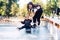 Young mother teaches her little boy to ride a skateboard