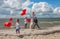 Young mother and three children with red balloons