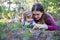 Young mother and toddler girl lying on the ground looking down