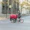 Young mother transports her child in a bicycle buggy in Berlin