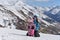 A young mother travels in the mountains with her little daughter on a Sunny winter