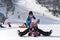 A young mother travels in the mountains with her little daughter on a Sunny winter