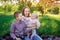 Young mother with two children on a picnic in the Park. Tenderness and care