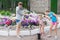 Young mother with two daughters blow giant bubbles outdoor