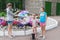 Young mother with two daughters blow giant bubbles outdoor