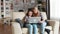 Young mother using laptop for her daughter education